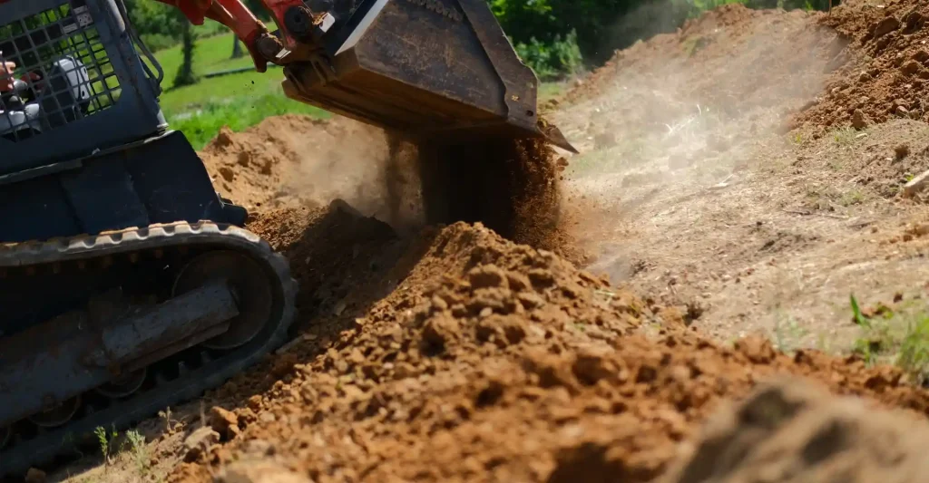 skid steer moving soil for land grading